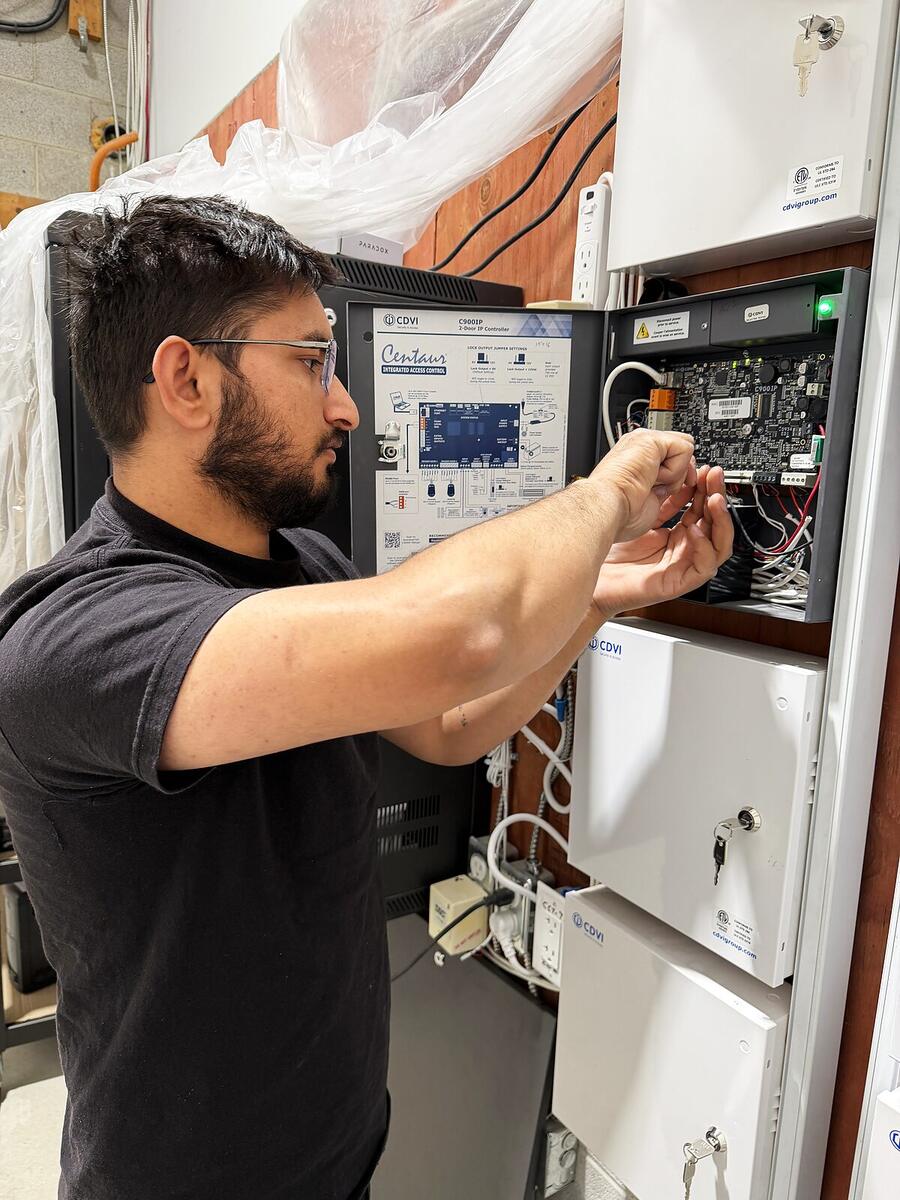 RM Security Services technician wiring a CDVI access control panel