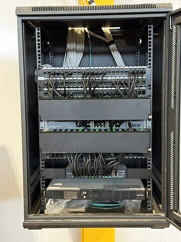 Commercial network rack with patch panels and switches, cables dressed neatly