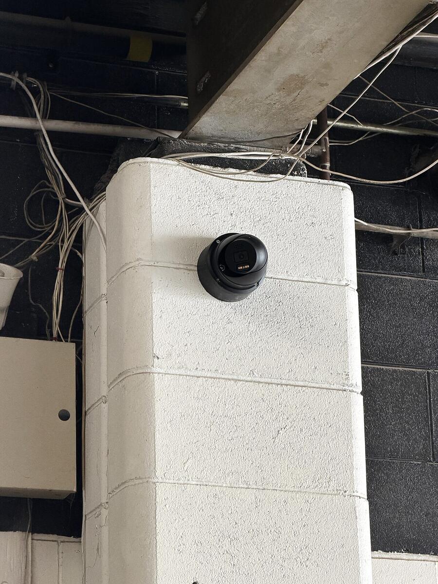 Camera mounted on a painted column inside an industrial unit